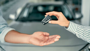Car keys being handed to another driver