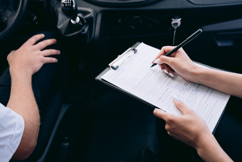 Insurance form being completed inside a car for FR44 application