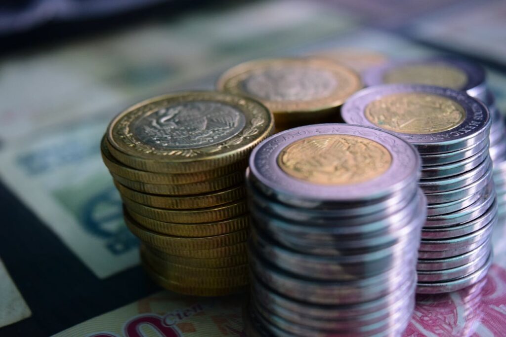 Stacked coins and currency representing savings on FR44 insurance premiums